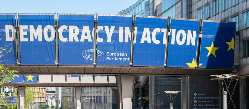 19 May 2026, Brussels, Belgium. European Parliament building with &ldquo;Democracy in Action&rdquo; banner and EU flag in institutional district