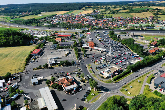 Geiselwind, Germany - 21 June 2025: Aerial view of the Eventzentrum Strohofer Geiselwind musichall and surrounding truck stop facilities with parking lots and the A3 motorway.