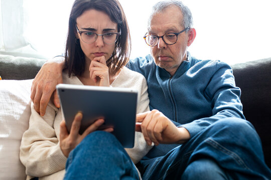 Father daughter learning digital technology together on tablet