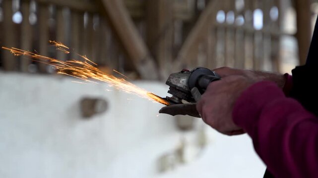 Industrial Worker Grinding Metal With Angle Grinder And Sparks