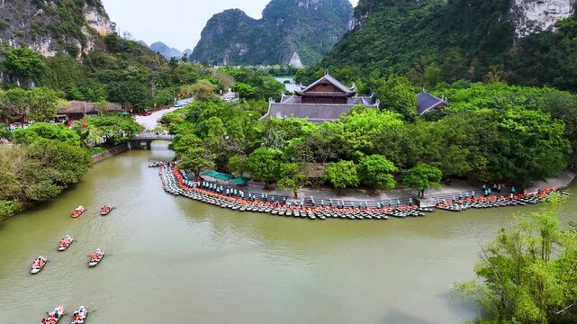 Aerial view of Trang An scenic area with boat cave tours near Ninh Binh, Vietnam.