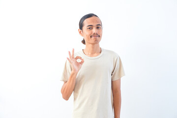 Naklejka premium Young Asian man in a shirt, give OK or approved sign expression. Isolated in white background