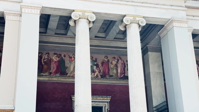 Greek Flag Waving Proudly Above Athens University Building.