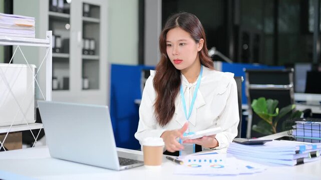 Business woman using tablet and laptop for doing math finance on an office desk, tax, report, accounting, statistics, and analytical research concept in office