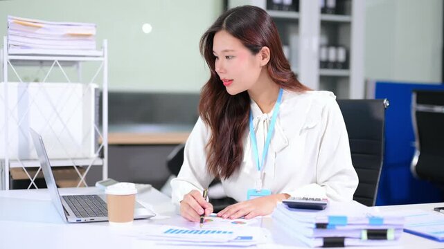 Business woman using tablet and laptop for doing math finance on an office desk, tax, report, accounting, statistics, and analytical research concept in office