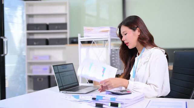 Business woman using tablet and laptop for doing math finance on an office desk, tax, report, accounting, statistics, and analytical research concept in office