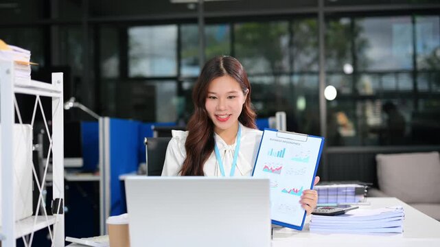 Business woman using tablet and laptop for doing math finance on an office desk, tax, report, accounting, statistics, and analytical research concept in office