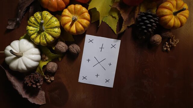 Flatlay autumn scene with pumpkins and mockup card, overhead wooden surface with apples, pinecones and scattered leaves clean space for copy, warm tones, editorial layout for branding or seasonal