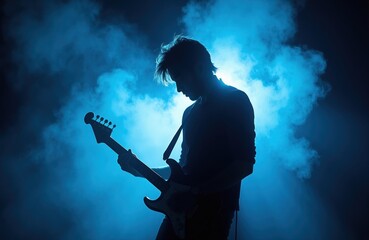 Obraz premium Musician silhouette plays electric guitar in blue smoke on stage. Dark background, atmospheric concert performance. Sound, talent, passion, musical art.