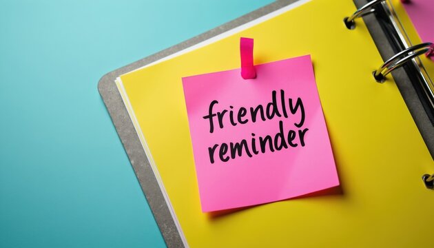 Pink sticky note with friendly reminder text on yellow notepad page. Simple message on office paper attached with pink ribbon. Planning reminder on desk.