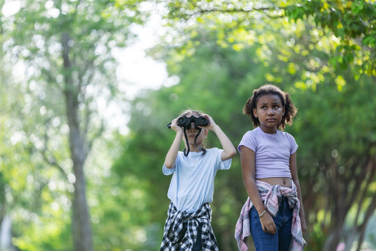 Multicultural Children Exploring Nature with Binoculars During Outdoor Eco Education Activity