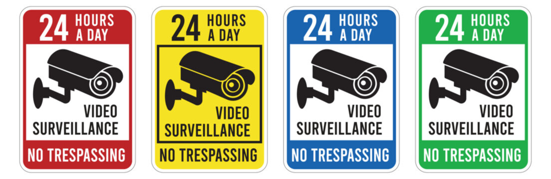 video surveillance signs with security camera icons and no trespassing warnings yellow and green