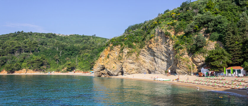 Budva, Montenegro - wide panoramic coastal bay with turquoise water and shoreline near Mogren Beach