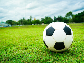 Fototapeta premium A football placed on the grass field of a football stadium. 2026 World Cup. Soccer sports, activity outdoors 