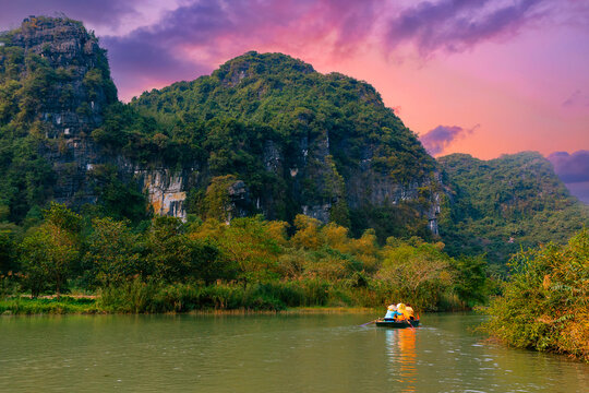 Scenic sunset boat ride in Ninh Binh, Vietnam's stunning karst landscape