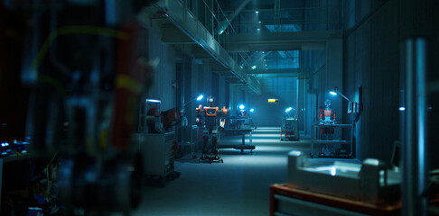 Industrial factory workshop interior with blue dim lighting and equipment © islamamar
