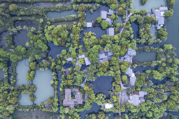 Fototapeta premium Hangzhou Xixi Wetland Park with ponds and traditional buildings