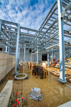 Active construction site exterior showing cranes, scaffolding, and high-rise building progress