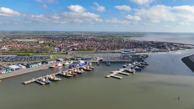 Fishing harbor with historic city at the Wadden Sea in Europe