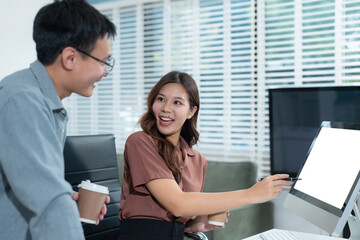 Fototapeta premium Business team analyzing documents, graphs, and data with a laptop, tablet, and smartphone. Collaboration, strategy, and success.