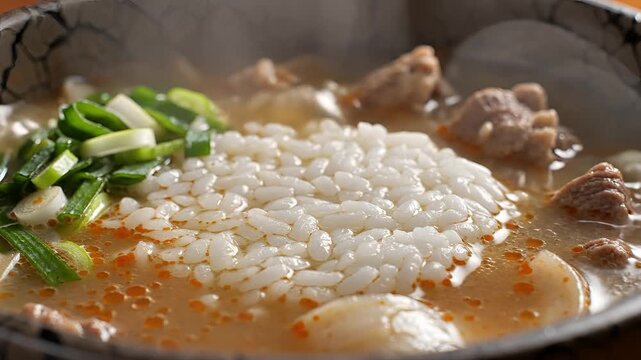 Steaming Hot Bowl of Japanese Oden with Rice and Green Onions.