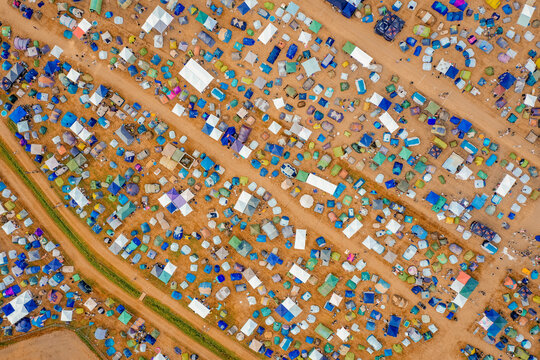 Herzogenaurach, Germany - 22 July 2022: Aerial view of the Open Beatz Festival campsite with hundreds of colorful tents arranged in rows along dirt paths.