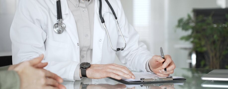 Doctor man writing prescription during patient consultation in clinic, providing medical advice and healthcare service. Medicine, health care and science concept