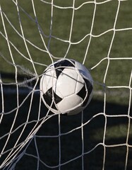 Naklejka premium Soccer ball hitting the goal net during a professional football match