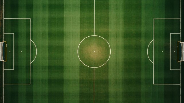Aerial view of a green soccer field with white markings on the grass