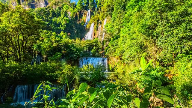 Time Lapse Adventure travelers explore the stunning landscape of Thi Lor Su Waterfall, one of Thailand is most beautiful waterfalls, hidden deep within the lush forest of Tak Province.