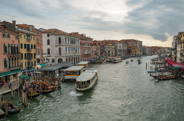 Fototapeta premium Italy, Venice, September 30, 2025, boats on the Grand Canal, with charming townhouses behind them in Venice