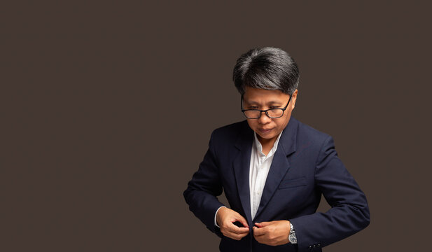 Confident Female Executive Adjusting Blazer in Studio