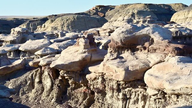 landscape features the unique geological formations of the Bisti De-Na-Zin Wilderness Area in New Mexico