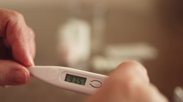 Thermometer. Measure body temperature. Fahrenheit. Slow motion video. High quality 4k footage
