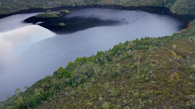 Woods on shores of Dove lake in Cradle Mountain national park of Tasmania &ndash; aerial lift.