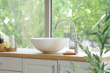 Fototapeta premium Stylish sink and decorative olive tree in modern bathroom