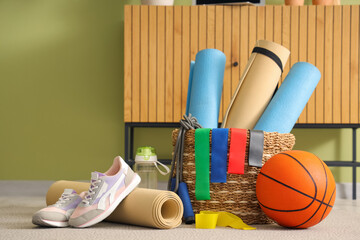 Obraz premium Sports equipment with sneakers on carpet in living room