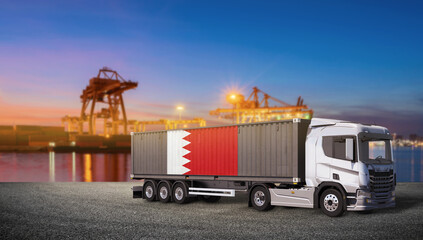 Bahrain Flag on Shipping Container Truck in Port: A modern container truck bearing the flag of Bahrain stands ready for transport in a busy harbor at sunset. © bao