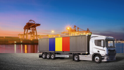 Romanian Logistics Hub: A modern semi-truck carrying a shipping container adorned with the Romanian flag stands ready at a bustling port, illuminated by the twilight sky. © bao