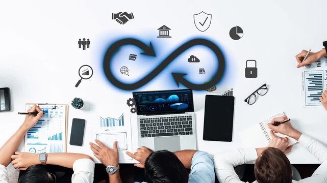 A group of professionals collaborates on a digital transformation strategy, showcasing technology tools, graphs, and an infinity symbol representing endless possibilities. Raster