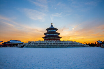 Fototapeta premium The Hall of Prayer for Good Harvests at the Temple of Heaven with sunset glow after snow, Beijing, China