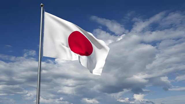 Japanese flag waving in the wind against a cloudy blue sky.