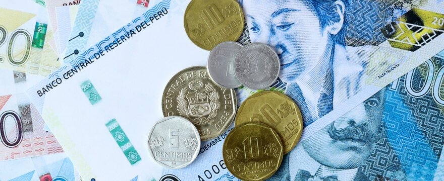Peruvian sol money bills and coins on table. Peru cash of PEN currency