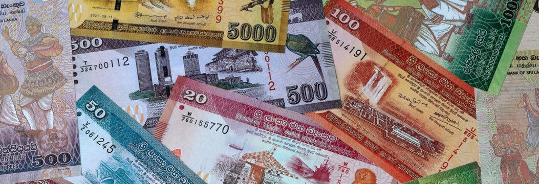 Sri Lankan rupee money banknotes bunch on table. Sri Lanka bills of LKR currency close up
