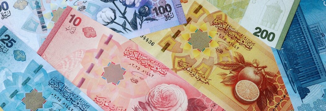 Syrian pound money banknotes bunch on table. Syria bills of SYP currency close up