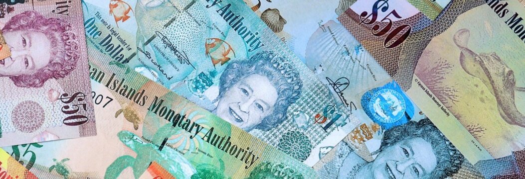 Cayman Islands dollar money banknotes bunch on table. Cayman Islands bills of KYD currency