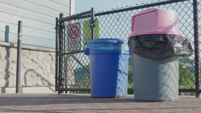 Victoria, British Columbia, Canada &ndash; May 24, 2026: Public garbage cans and recycling bins in a park