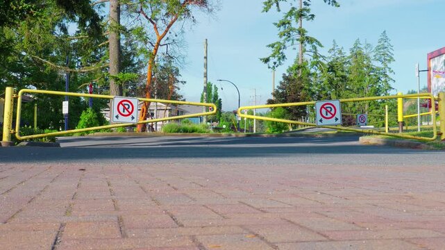 Langford, BC, Canada &ndash; May 24, 2026: No parking signs on yellow gate barrier