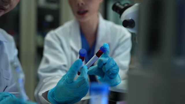 Lab work, Doctor holds a test tube takes the test from a test tube in analysis, blood, DNA, test tube stand.