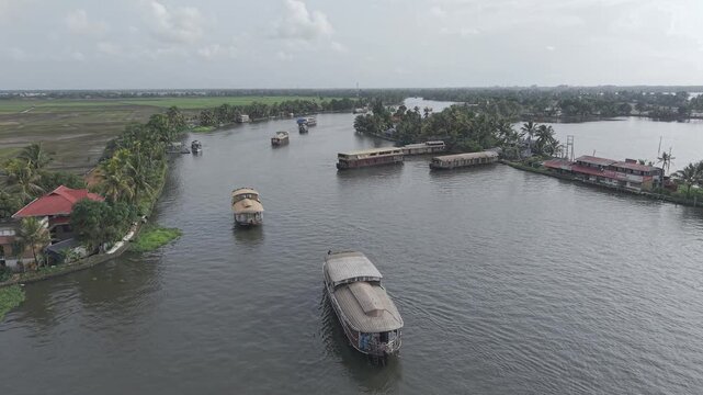 Aerial drone view of traditional houseboats on Kerala backwaters, Alappuzha, India.
